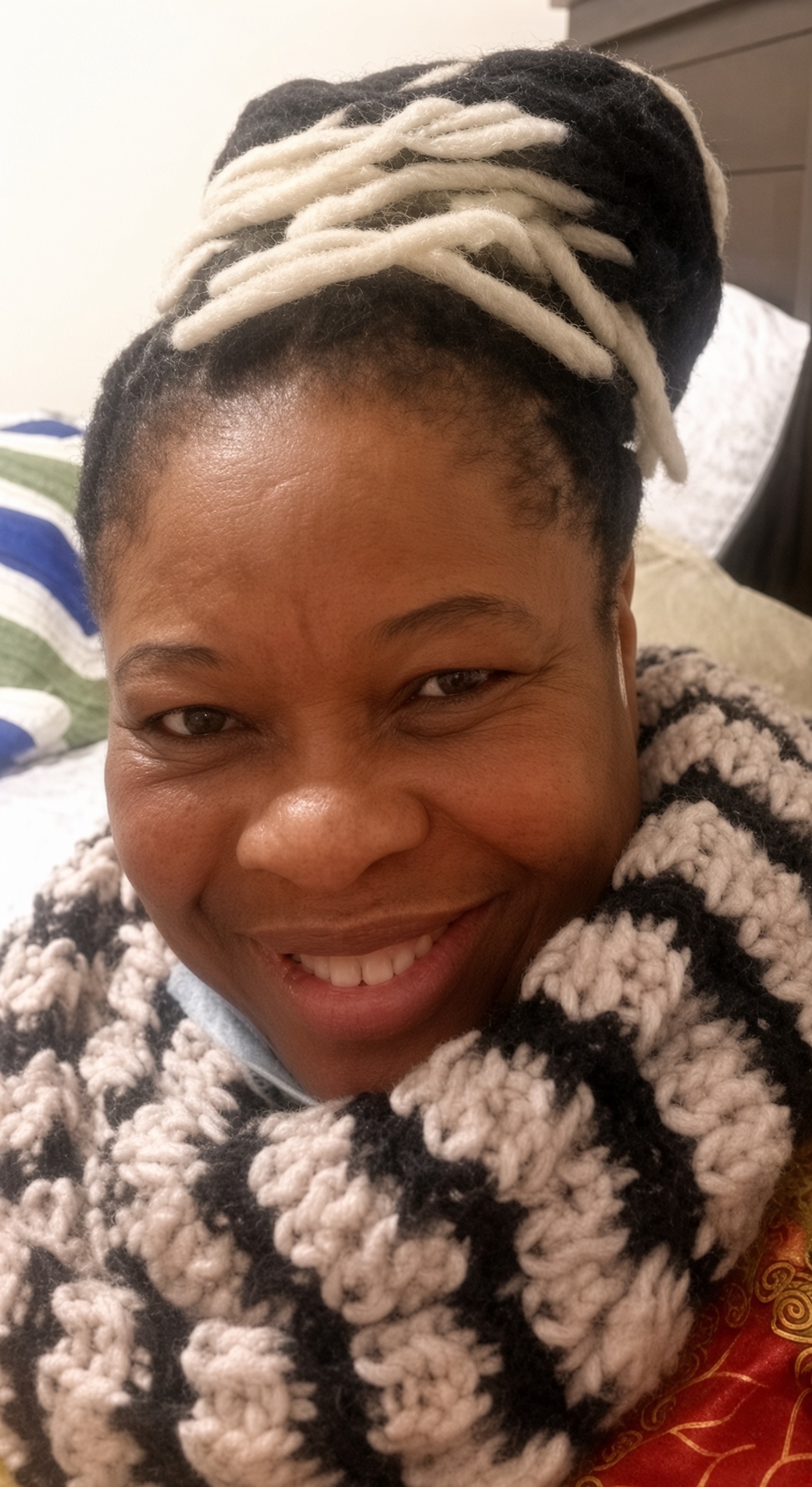 A smiling portrait in patterned knitwear
